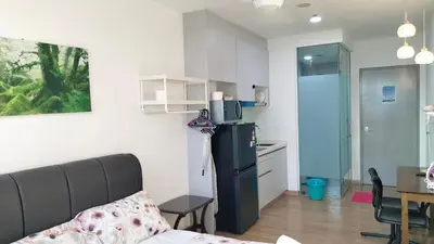 a kitchen with a refrigerator and a table in a room at Riveria City KL Sentral by Jane in Kuala Lumpur