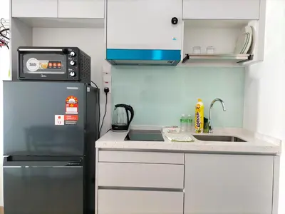 a small kitchen with a refrigerator and a sink at Riveria City KL Sentral by Jane in Kuala Lumpur