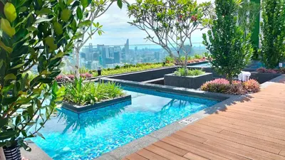 a swimming pool in the middle of a garden at Riveria City KL Sentral by Jane in Kuala Lumpur