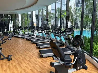 a gym with rows of exercise bikes and a pool at Cozy studio service suite Free parking Netflix Trion B5206 KL in Kuala Lumpur