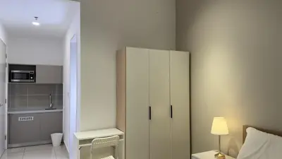 a bedroom with a white cabinet and a bed at Cozy studio service suite Free parking Netflix Trion B5206 KL in Kuala Lumpur