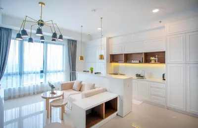 a kitchen and living room with a couch and a table at Novo Kuala Lumpur by Cobnb, Jalan Ampang in Kuala Lumpur