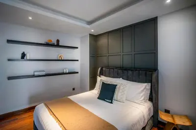 a bedroom with a bed with a black headboard at Novo Kuala Lumpur by Cobnb, Jalan Ampang in Kuala Lumpur