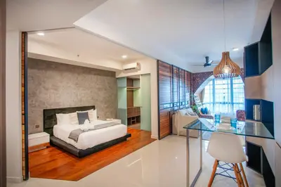 a bedroom with a bed and a glass table at Novo Kuala Lumpur by Cobnb, Jalan Ampang in Kuala Lumpur