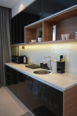 a kitchen with a sink and a counter top at Novo Kuala Lumpur by Cobnb, Jalan Ampang in Kuala Lumpur