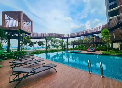a swimming pool with lounge chairs and a bridge over it at trion2 Kuala lumper near KLCC TRX bukit bin tang in Kuala Lumpur