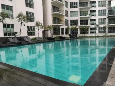 a large swimming pool in front of a building at Infinity Pool Hostel in Kuala Lumpur