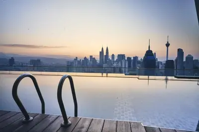 a view of a city skyline from a swimming pool at Infinity Pool Hostel in Kuala Lumpur
