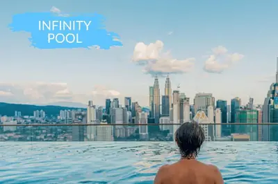 a man sitting in a infinity pool overlooking a city at Infinity Pool Hostel in Kuala Lumpur