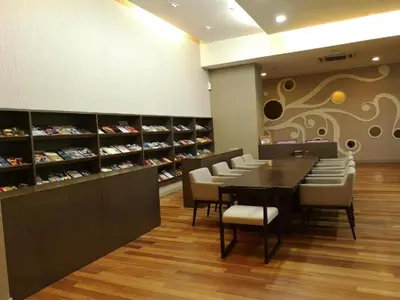 a dining room with a table and chairs in a store at KL Infinity Pool Hostel in Kuala Lumpur