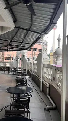 a row of tables and chairs on a roof at Hotel AL Amin By Ahmed in Kuala Lumpur
