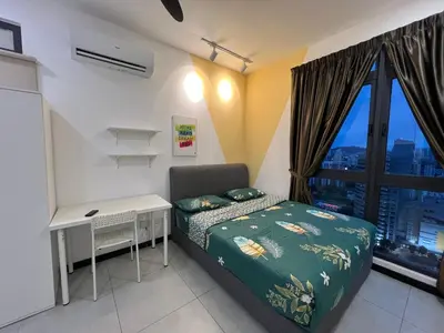 a bedroom with a bed and a desk and a window at Rainbowstudioklcc in Kuala Lumpur