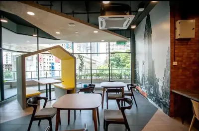 a restaurant with tables and chairs and a large window at Rainbowstudioklcc in Kuala Lumpur