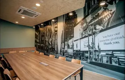 a conference room with a wooden table and chairs at Rainbowstudioklcc in Kuala Lumpur