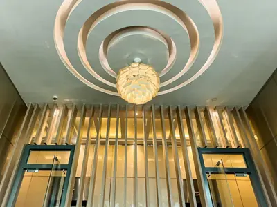 a chandelier hanging from a ceiling with two windows at Sky Suite KLCC in Kuala Lumpur