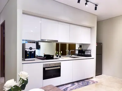 a kitchen with white cabinets and appliances at Sky Suite KLCC in Kuala Lumpur