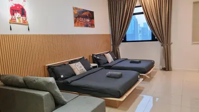 two beds in a room with a couch and a window at Chambers Suites KLCC By City Homes in Kuala Lumpur