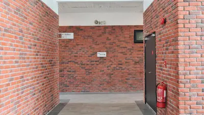 a brick wall with a fire hydrant in a room at Chambers Suites KLCC By City Homes in Kuala Lumpur