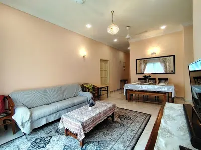 a living room with a couch and a table at Homestay Spacious Condo Gurney Heights 5min to KLCC in Kuala Lumpur