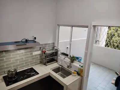 a small kitchen with a sink and a stove at Homestay Spacious Condo Gurney Heights 5min to KLCC in Kuala Lumpur