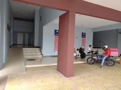 a man sitting on a motorcycle in a building at Homestay Spacious Condo Gurney Heights 5min to KLCC in Kuala Lumpur