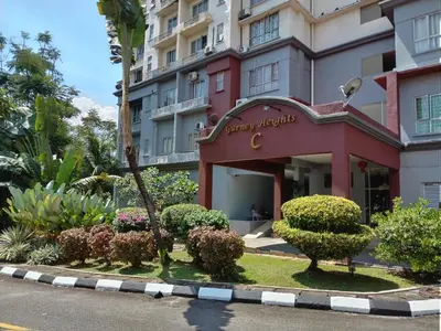 a red building with bushes in front of it at Homestay Spacious Condo Gurney Heights 5min to KLCC in Kuala Lumpur
