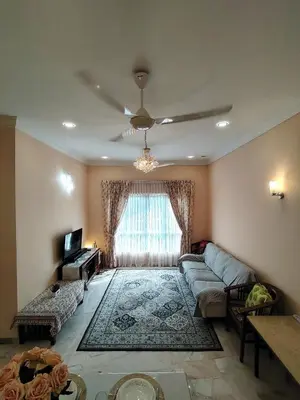 a living room with a couch and a window at Homestay Spacious Condo Gurney Heights 5min to KLCC in Kuala Lumpur