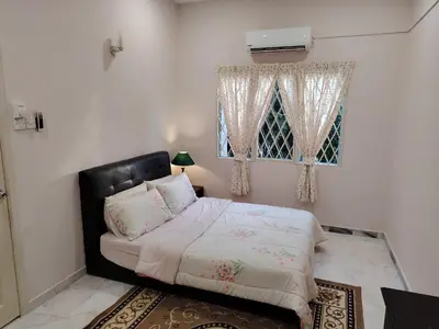 a bedroom with a bed and a window at Homestay Spacious Condo Gurney Heights 5min to KLCC in Kuala Lumpur