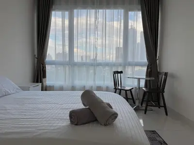 a bedroom with a bed with two towels on it at ABC PRiVATE RooM Klcc in Kuala Lumpur