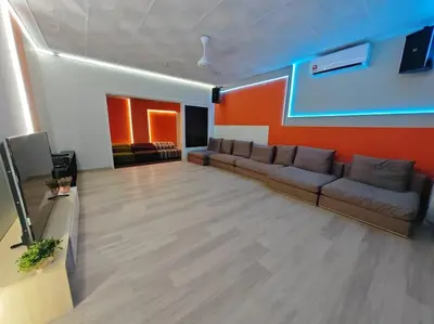 a living room with a couch and a television at Taman Duta KL Deluxe Villa by uBook in Kuala Lumpur
