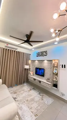 a living room with a ceiling fan and a tv at Inara Homestay in Kuala Lumpur
