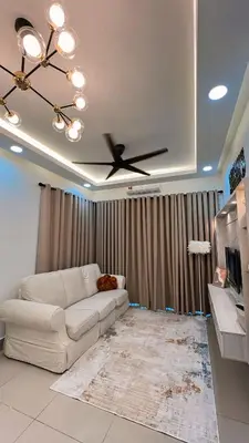 a living room with a white couch and a ceiling fan at Inara Homestay in Kuala Lumpur