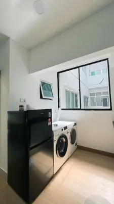 a laundry room with a washing machine and a window at Inara Homestay in Kuala Lumpur