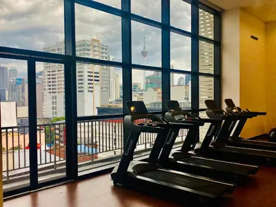 a gym with a view of the city from a large window at Chamber Suites By Kuala Lumpur in Kuala Lumpur