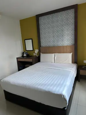 a bedroom with a large bed with a large headboard at South of The Clouds HOTEL KL Sentral \u5409\u9686\u5761\u5f69\u4e91\u4e4b\u5357\u9152\u5e97-\u4e2d\u592e\u8f66\u7ad9\u5e97 in Kuala Lumpur