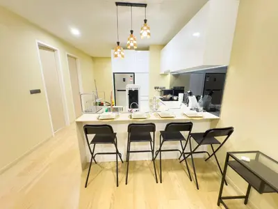 a kitchen with a large island with four chairs at Family comfy 2BR at Star residence2 KLCC in Kuala Lumpur