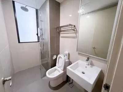 a white bathroom with a toilet and a sink at PROMO Connected train 3 Bedrooms - Above Mall 25 in Kuala Lumpur