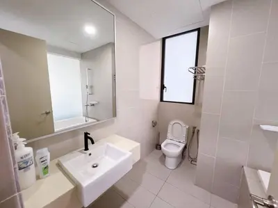 a white bathroom with a sink and a toilet at PROMO Connected train 3 Bedrooms - Above Mall 25 in Kuala Lumpur