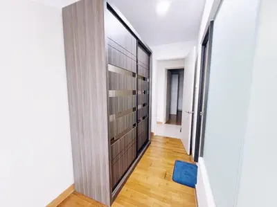 a hallway with a large wooden cabinet in a room at PROMO Connected train 3 Bedrooms - Above Mall 25 in Kuala Lumpur