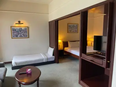 a hotel room with two beds and a television at KL Elegant Apartment at Times Square in Kuala Lumpur