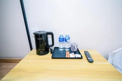 a table with a coffee maker and water bottles on it at Swing & Pillows - Times Square, Bukit Bintang in Kuala Lumpur