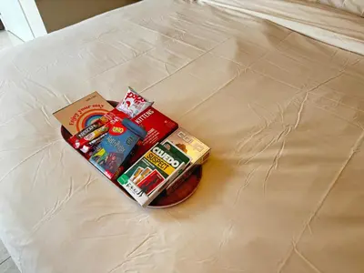 a pile of food and books on a bed at Dorsett Residence Sri Hartamas by Chengal with Bathtub, Rooftop Pool, KL City Centre, Round the Clock Security, Netflix, Youtube, Free Parking in Kuala Lumpur