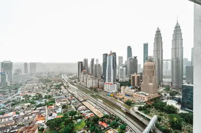 an aerial view of a city with tall buildings at Cozy Apartment with KLCC View & 1 Min to LRT Station in Kuala Lumpur