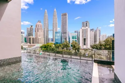 a view of a city with tall buildings at Cozy Apartment with KLCC View & 1 Min to LRT Station in Kuala Lumpur