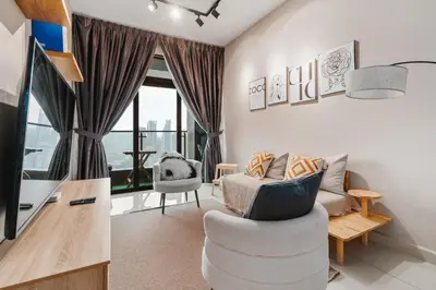 a living room with a couch and a chair at Cozy Apartment with KLCC View & 1 Min to LRT Station in Kuala Lumpur