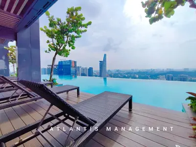 a swimming pool with a bench on the deck of a building at KL Eco City Luxury 2 Bedrooms Apartment, Walking Distance to Mid Valley & The Garden & LRT in Kuala Lumpur
