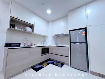 a kitchen with a floor grate in the middle of a refrigerator at KL Eco City Luxury 2 Bedrooms Apartment, Walking Distance to Mid Valley & The Garden & LRT in Kuala Lumpur