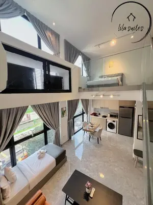 a large living room with a couch and a table at Lila Suites Agile, Bukit Bintang ,KLCC in Kuala Lumpur