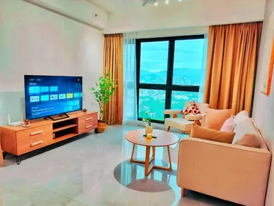 a living room with a tv and a couch and a table at Lila Suites Agile, Bukit Bintang ,KLCC in Kuala Lumpur