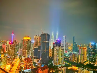 a view of a large city at night at Lila Suites Agile, Bukit Bintang ,KLCC in Kuala Lumpur